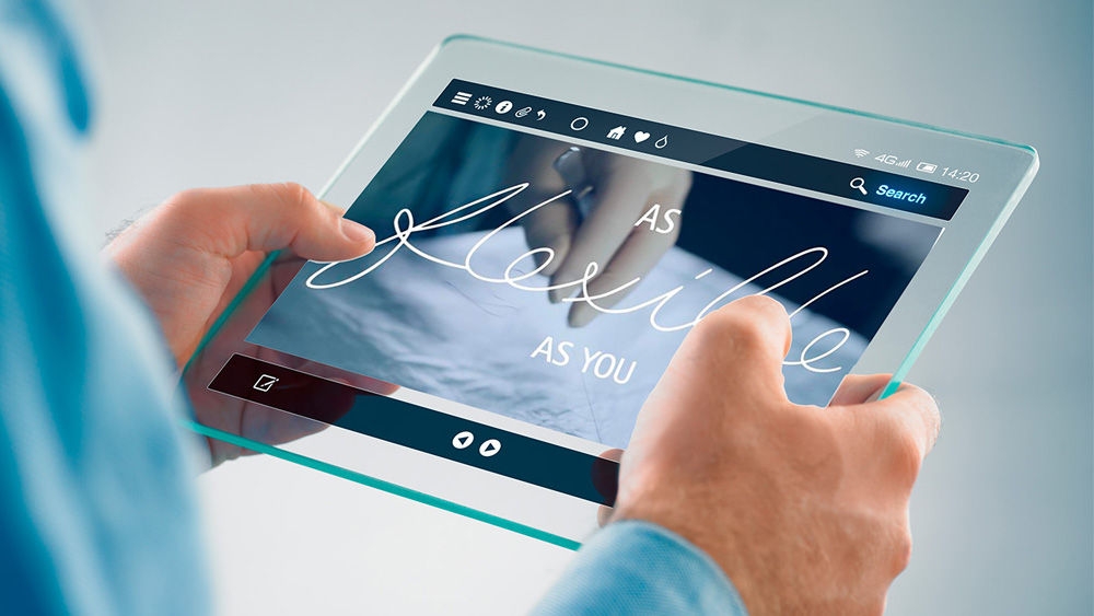 Two hands holding a tablet showing a scene of the Redefining abdominal wall closure with Monomax®  with the text overlay as flexible as you